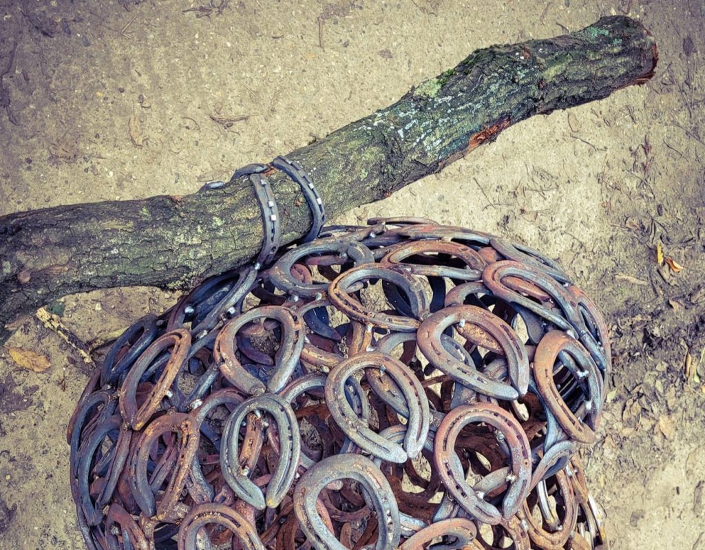 Forged horseshoe attaching stem to acorn