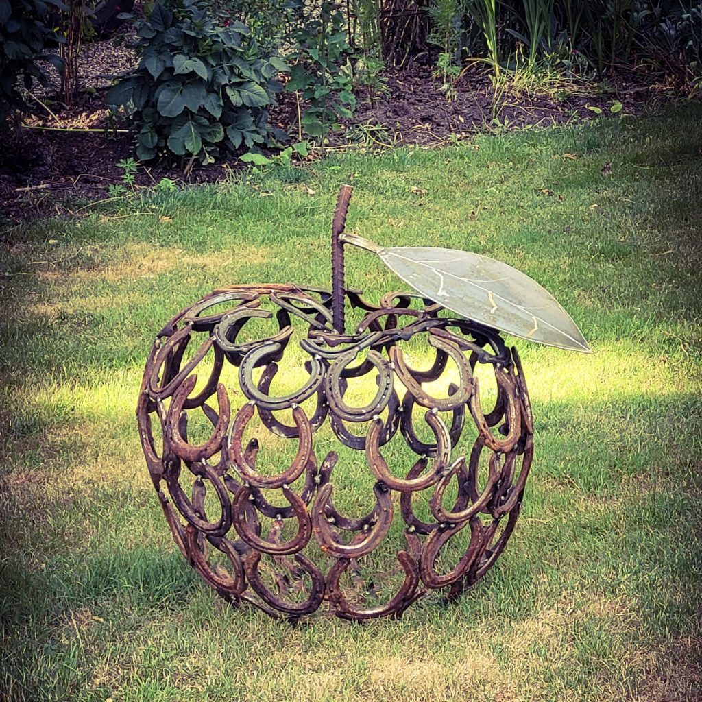 apple horseshoe sculpture in garden