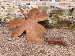 Maple leaf sculpture in comparison to standard size brick
