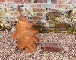 Oak leaf sculpture in size comparison to brick