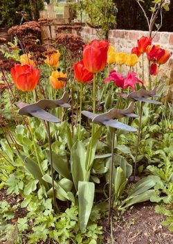 three planes in flower bed
