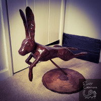 Leaping metal hare sculpture indoors