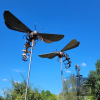 Metal art hornets against blue sky